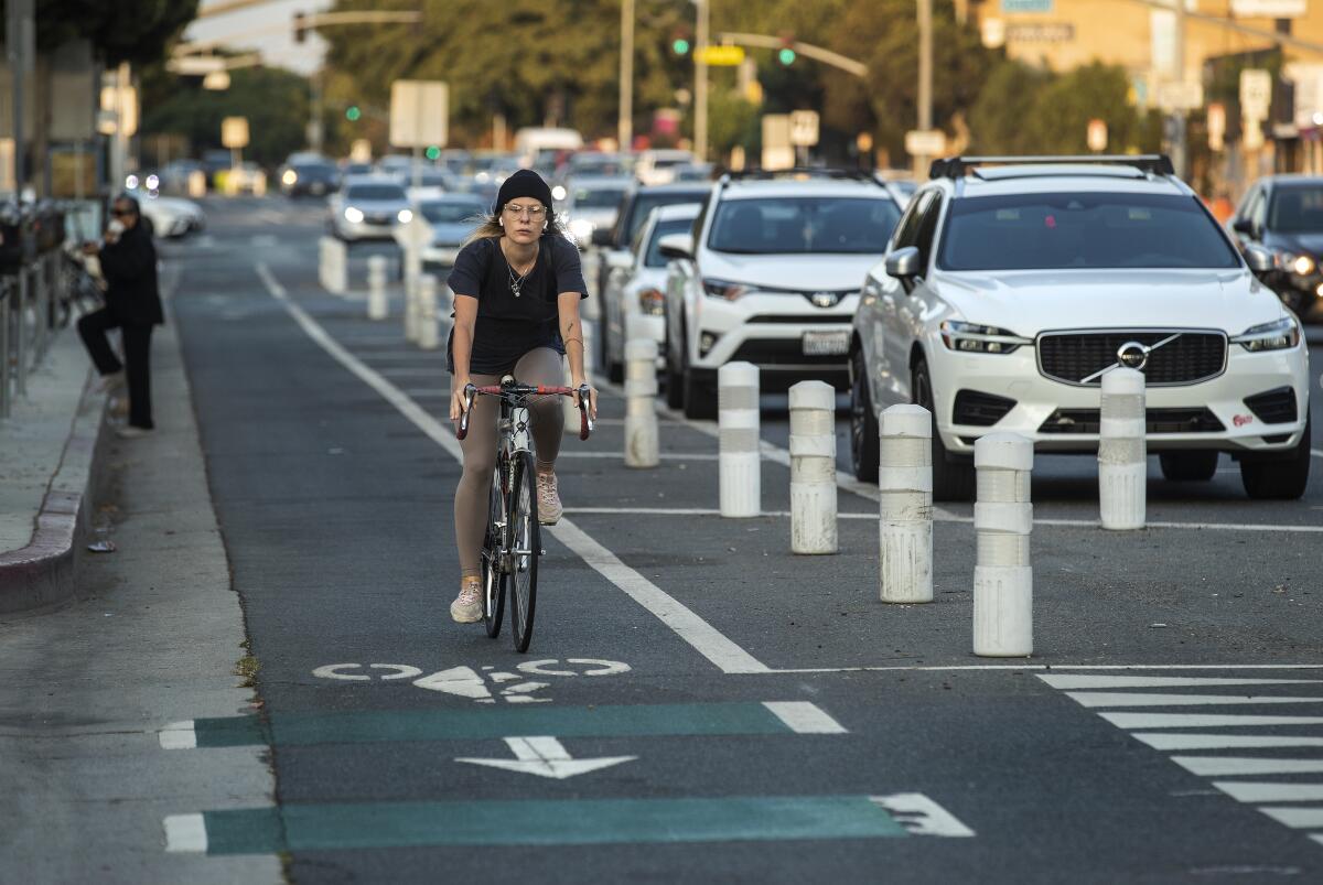 A bicyclist rides in a protected bike lane on Venice Boulevard in Mar Vista in 2021.