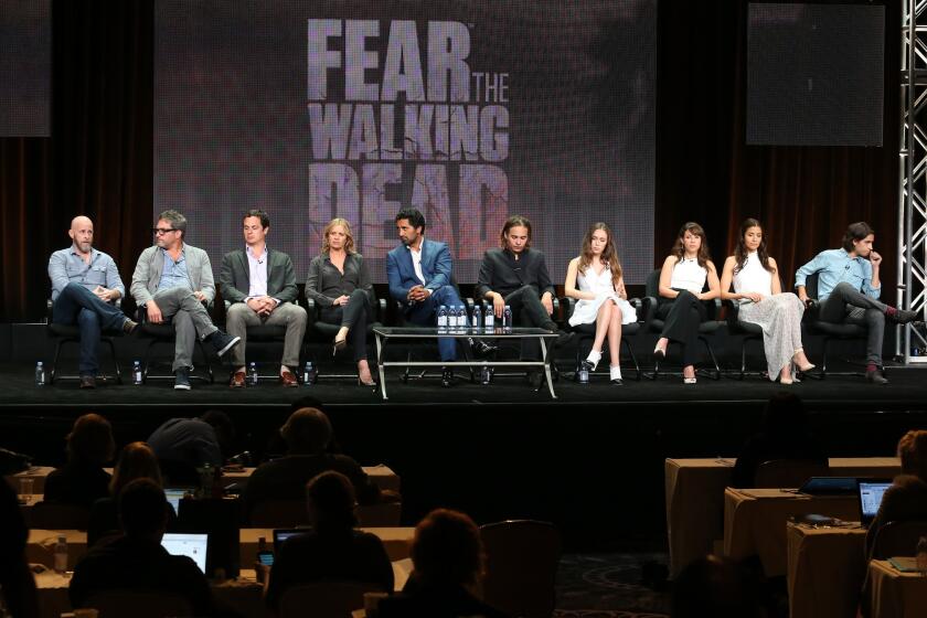 Executive producer and writer Dave Erickson, left, executive producer and director Adam Davidson, executive producer David Alpert, and actors Kim Dickens, Cliff Curtis, Frank Dillane, Alycia Debnam-Carey, Elizabeth Rodriguez, Mercedes Mason and Lorenzo James Henrie during the "Fear the Walking Dead" panel at AMC's TCA presentation.
