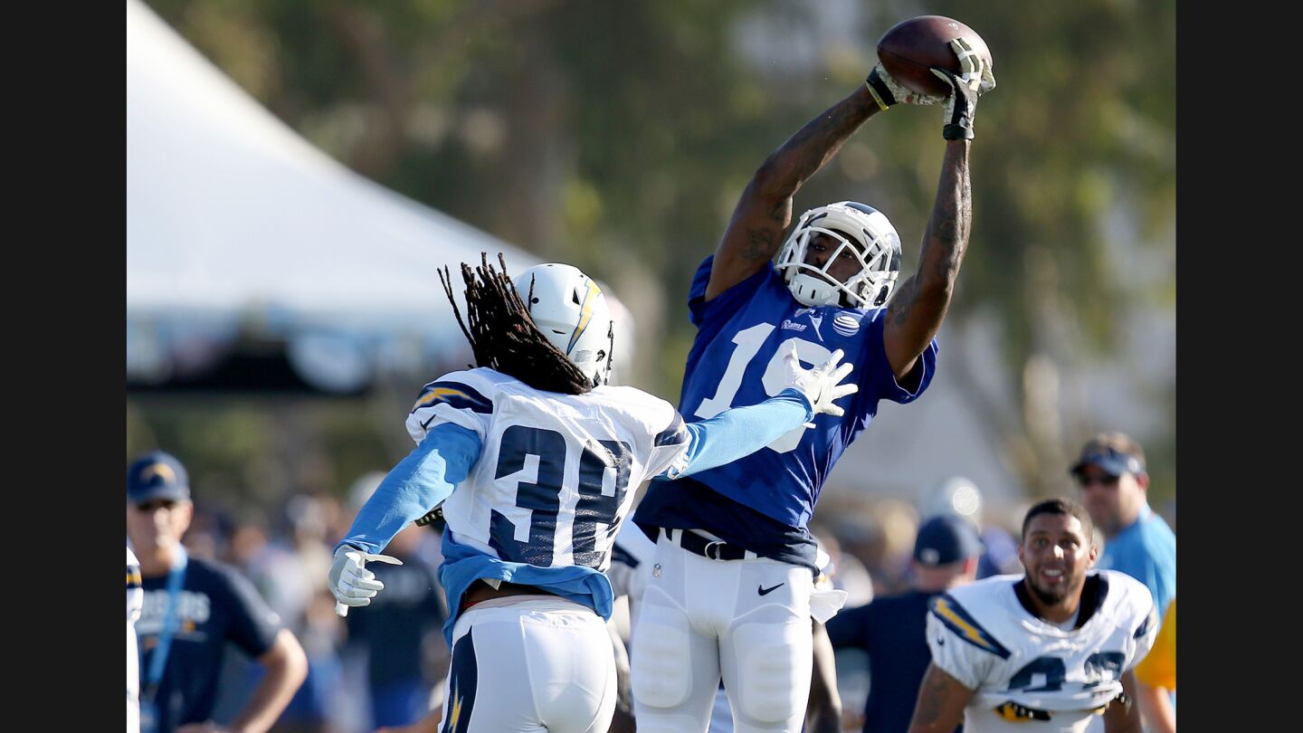 Rams wide receiver Paul McRoberts makes a catch against Chargers safety Trovon Reed.