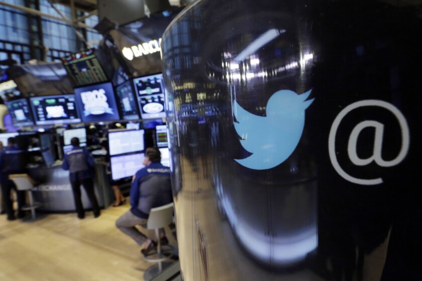 The Twitter logo appears on a phone post on the floor of the New York Stock Exchange. The company has been impacted by a range of security issues.