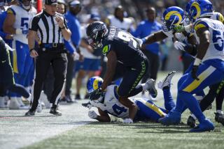 Seattle Seahawks running back Kenneth Walker III (9) is tackled by the Rams defense in the season opener.