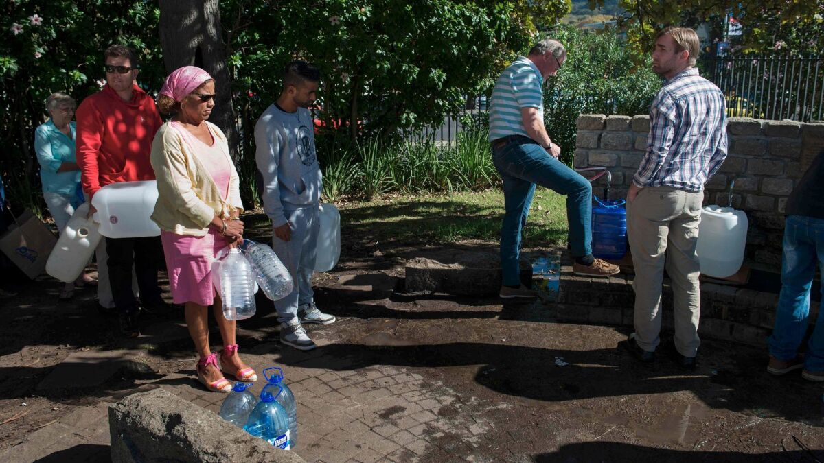 People line up on May 15 to collect drinking water from taps that are fed by a spring in Cape Town. South Africa's Western Cape province, which includes Cape Town, declared a drought disaster on Monday.