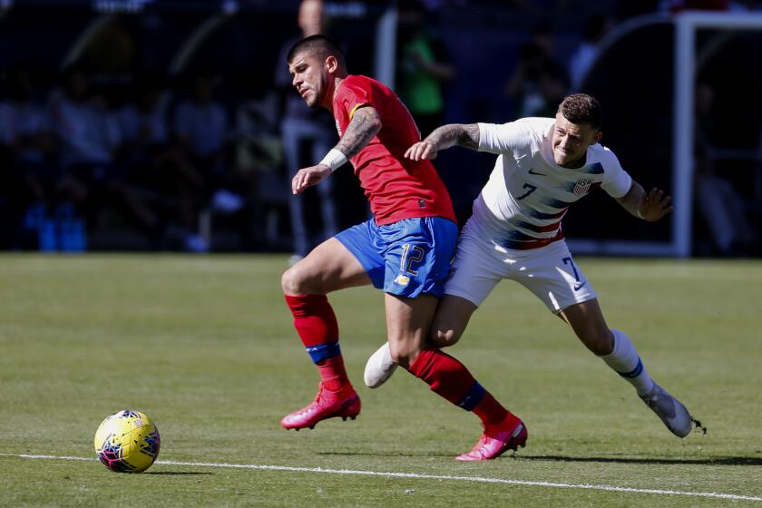 Costa Rica midfielder Ulises Segura (12) and United States forward Paul Arriola (7) vie for the ball during the first half of an international friendly soccer match in Carson, Calif., Saturday, Feb. 1, 2020. (AP Photo/Ringo H.W. Chiu)