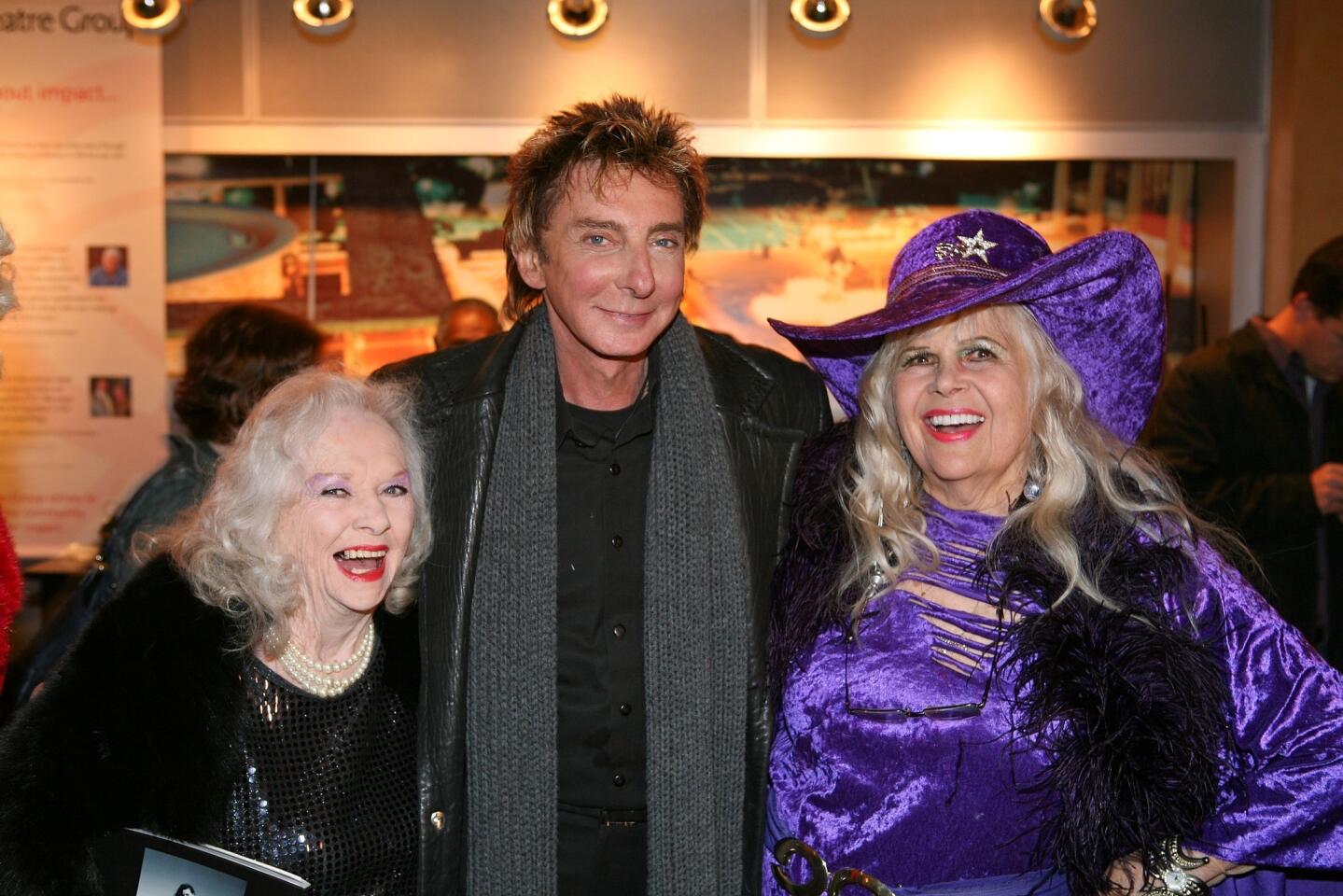 From left, Minsky's burlesque dancer Dixie Evans, Barry Manilow and Gloria Pall pose before the world premiere of the musical "Minsky's" at Ahmanson Theater in Los Angeles.