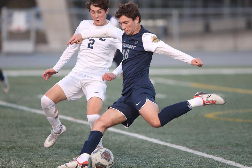 Newport Harbor's Jake Shubin (16) strikes in a goal as Will Hoshek can only look on during semifinals of the CIF Southern Section Division 2 boys' soccer playoffs against Loyola on Friday.