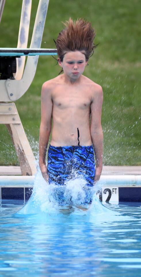 North Saint Johns' JP Yeich enters the water after one of his dives against West Howard in youth diving competition.