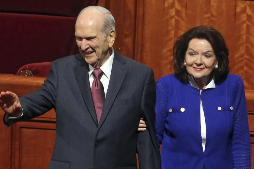 President Russell M. Nelson and his wife, Wendy, wave as they leave the morning session during the The Church of Jesus Christ of Latter-day Saints conference Saturday, April 6, 2019, in Salt Lake City. Church members are preparing for more changes as they gather in Utah for a twice-yearly conference to hear from the faith's top leaders. (AP Photo/Rick Bowmer)