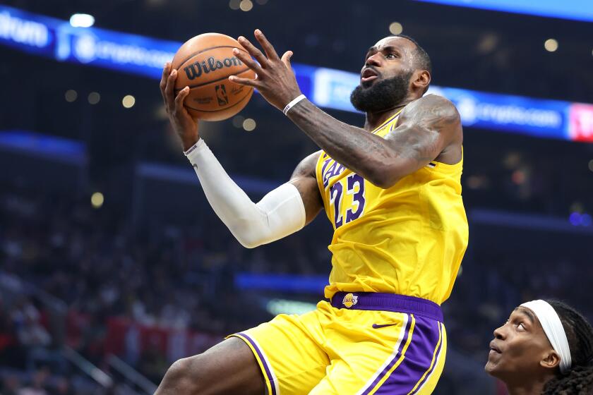 The Lakers' LeBron James drives past the Clippers' Terance Mann in the second quarter at Crypto.com Arena Wednesday.