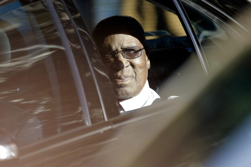 FILE — In this July 1, 2013 file photo, Andrew Mlangeni, a prison mate of former South African President Nelson Mandela, visits Mandela in hospital in Pretoria, South Africa. Mlangeni, who spent over two decades on Robben Island after he was convicted at the Rivonia Treason trial in 1964, has died at the age of 95. (AP Photo/Markus Schreiber/File)