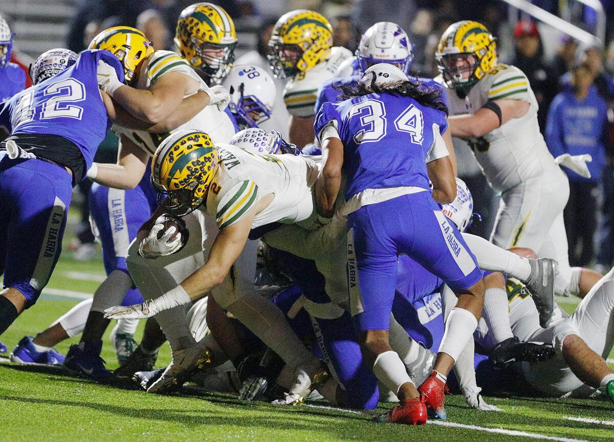 Edison's Mike Walters takes a direct snap and battles through the defense to score on a one-yard run against La Habra in the quarterfinals of the CIF Southern Section Division 3 playoffs on Friday.