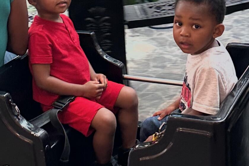 Twin brothers Jestine "Juju" James (left) and Josiah "Jojo" James on a ride at the mall. The twins died earlier this month after officials say they were exposed to fentanyl. Credit: Jestina James.