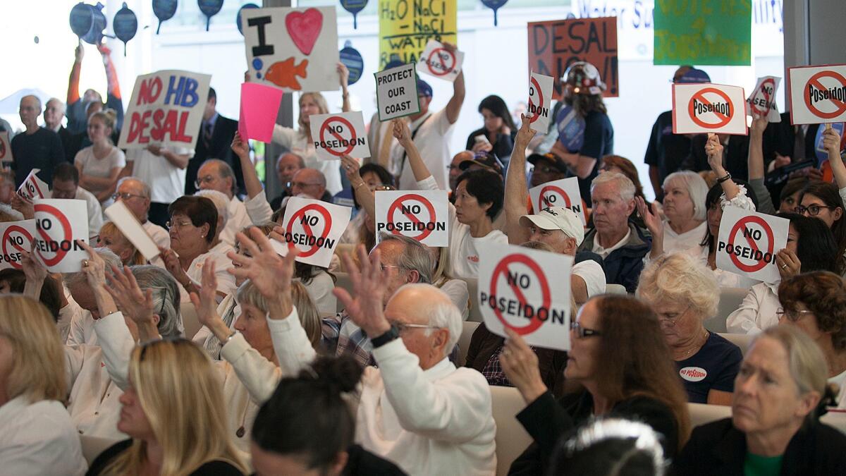Protesters against Poseidon Water's proposed Huntington Beach plant pack a California Coastal Commission meeting in 2013.