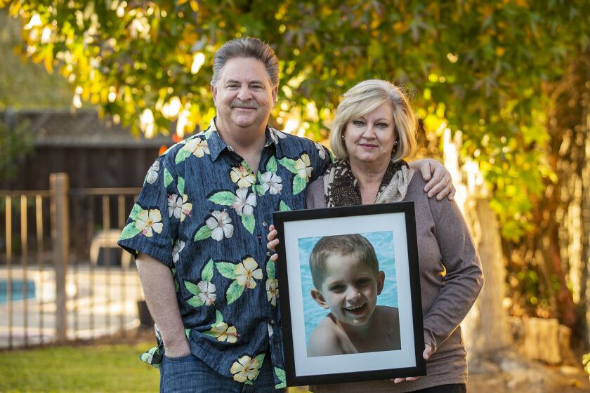 Richard and Andrea Dunn hold a photograph of their late son Julian, who died of Medulloblastoma, a type of brain cancer, in 2013. The Dunn's started a fund at Children's Hospital of Orange County called Julian's Lego Corner, where people can donate money or Legos to be distributed to children in the hospital.