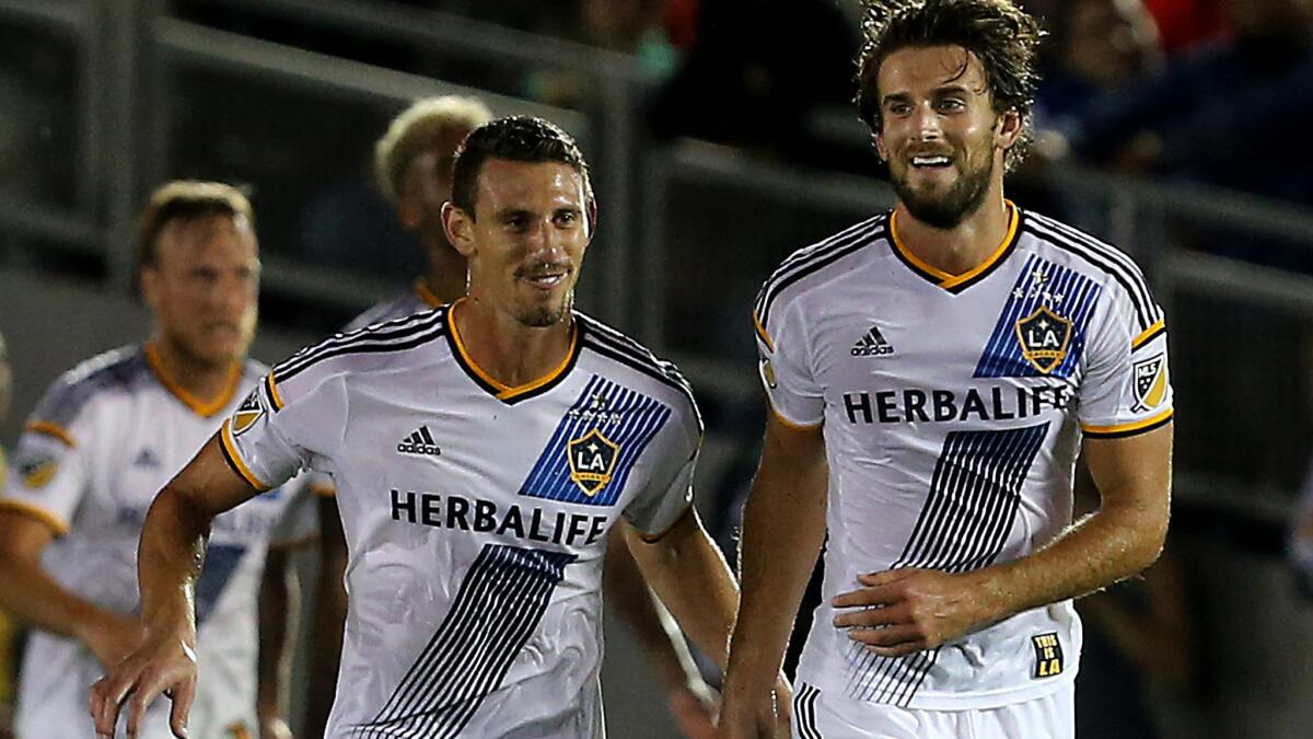 Galaxy defender Daniel Steres, left, is paid at the bottom end of the spectrum of top talent in MLS.