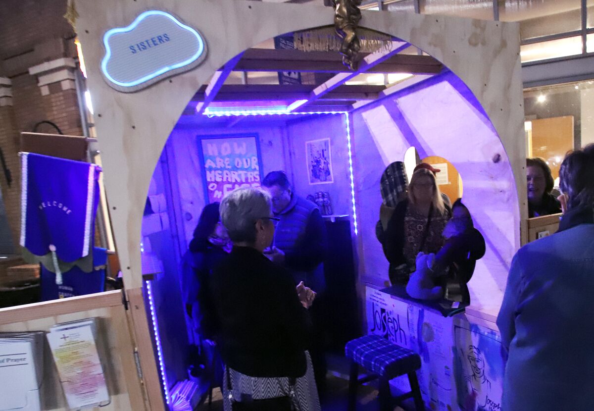 Guests gather in the Sisters InfoShop art installation.