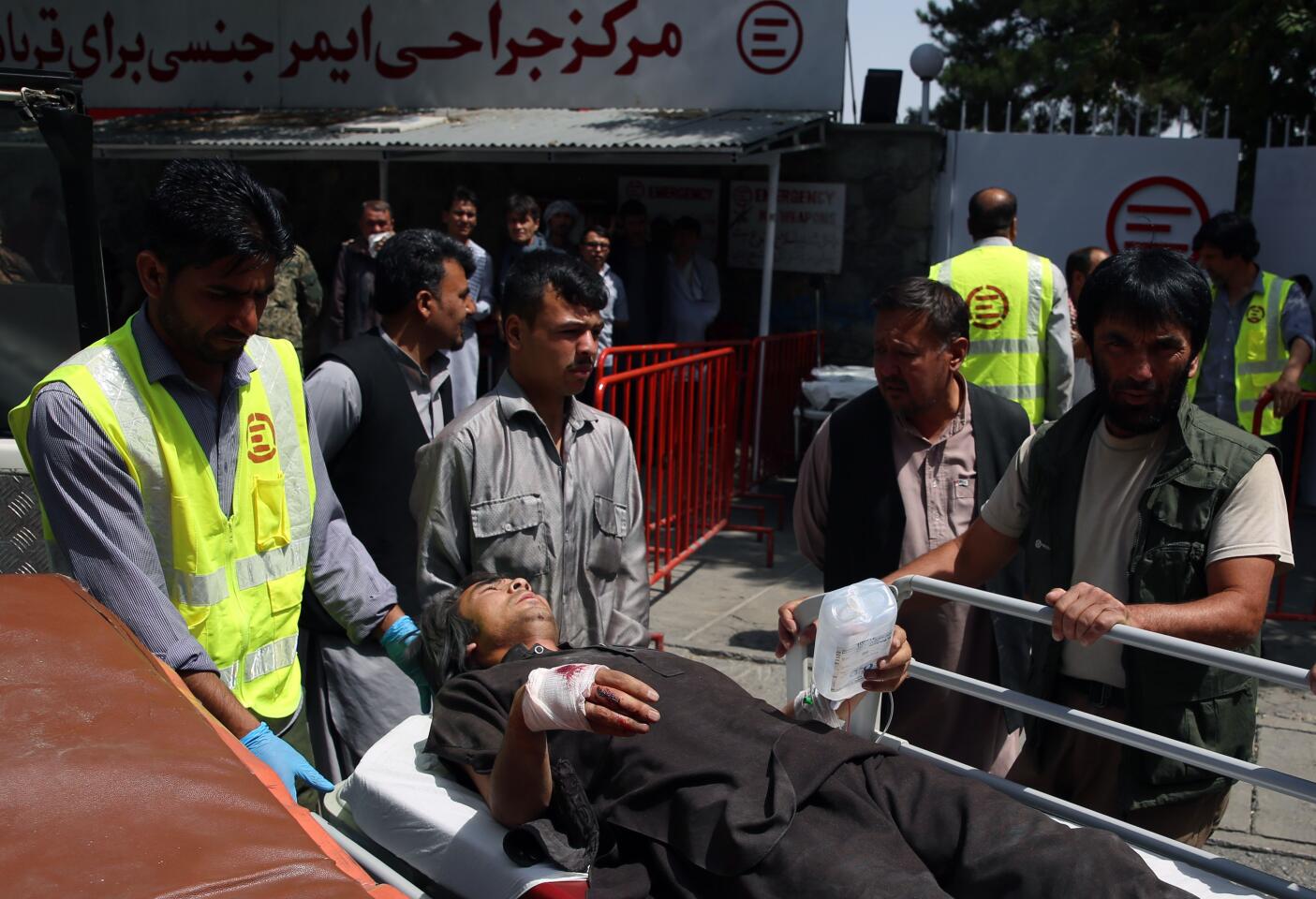 Afghan health workers take a wounded man to a hospital after an explosion Aug. 7 in Kabul.