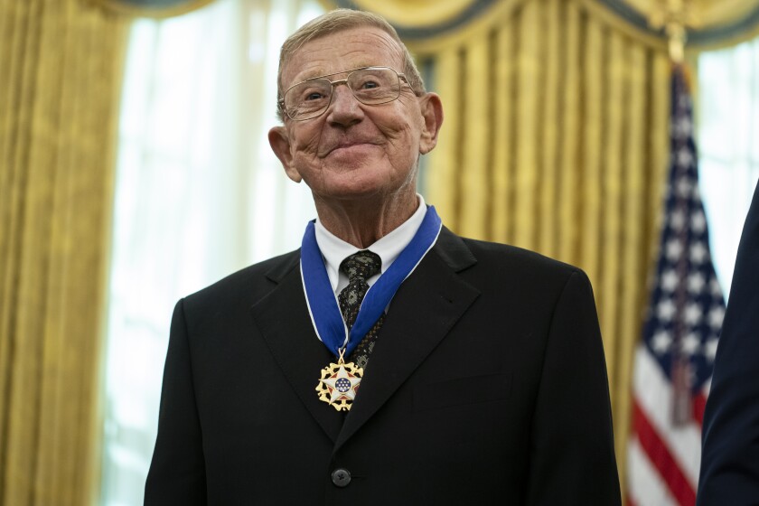 Former football coach Lou Holtz smiles after receiving the Presidential Medal of Freedom from President Donald Trump, in the Oval Office of the White House, Thursday, Dec. 3, 2020, in Washington. (AP Photo/Evan Vucci)
