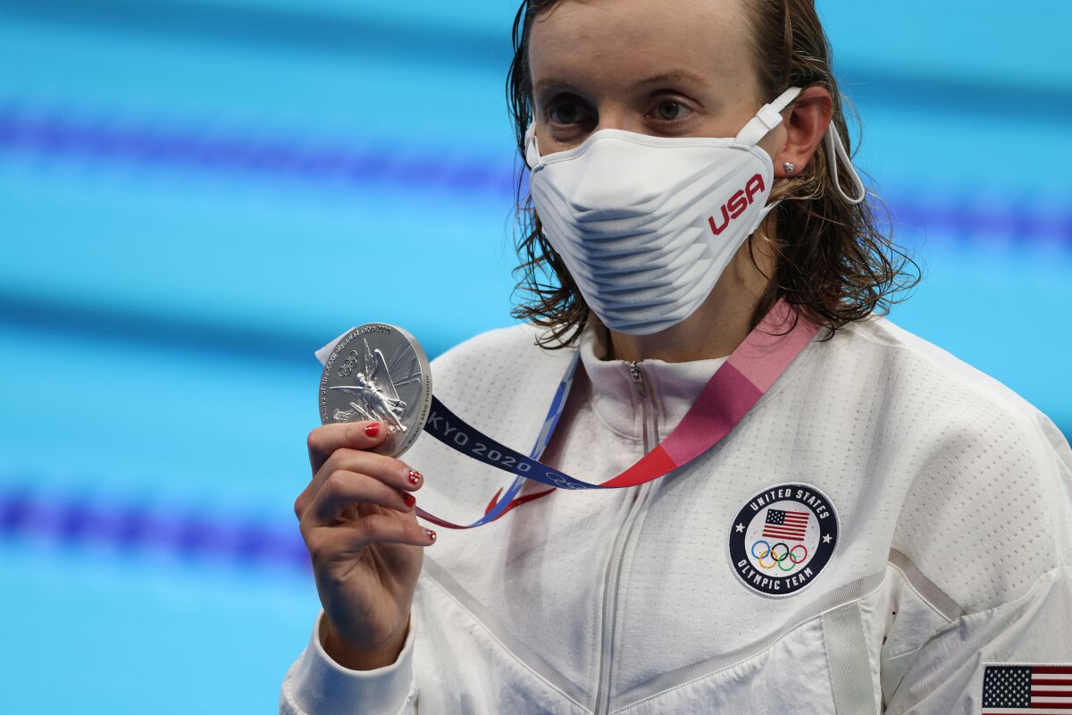 Katie Ledecky holds the silver medal she won for finishing second in the women's 400-meter freestyle.