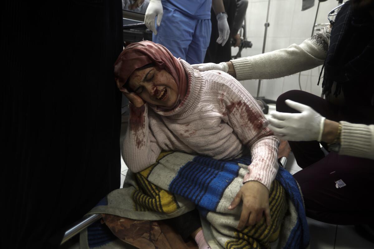 A Palestinian woman wounded in the Israeli bombardment of the Gaza Strip receives treatment 