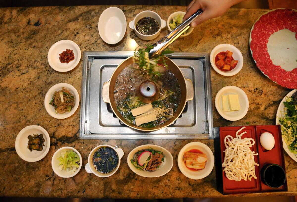 Prime beef and vegetables are prepared at Seoul Garden in Koreatown, which specializes in Korean hot pot.