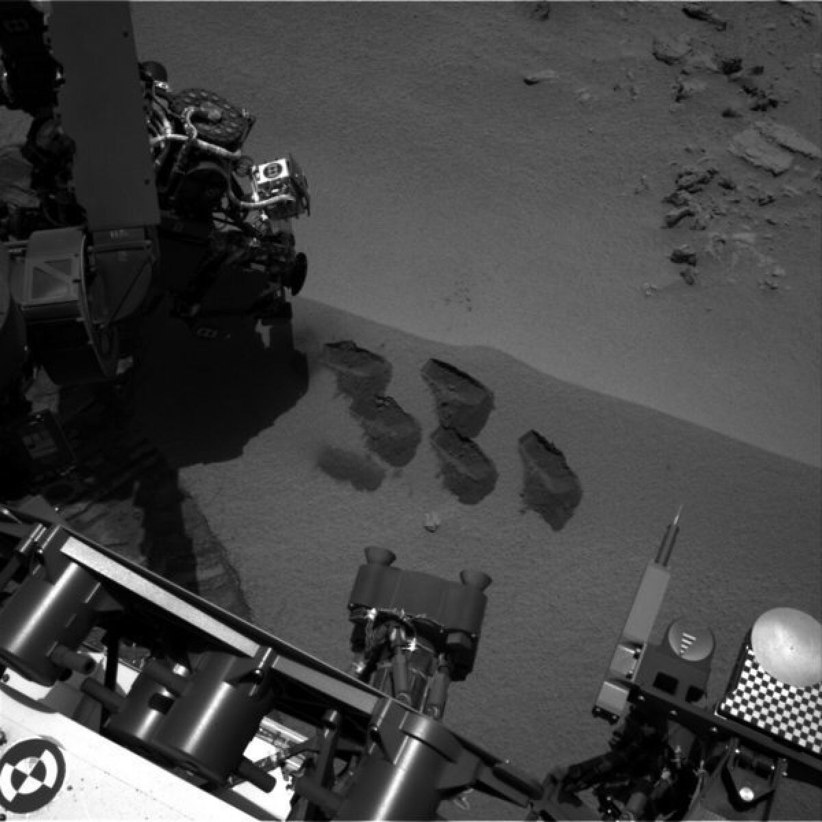 This NASA image shows marks in the Martian soil made by the rover Curiosity. It landed in August on a two-year mission to study whether Mars' environment is suitable for microbial life.