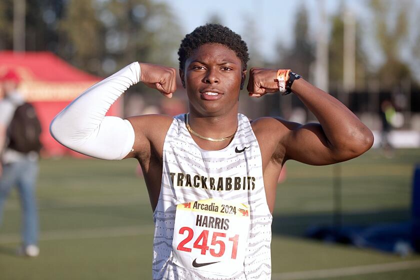 Long Beach Poly's Benjamin Harris flexes after winning the boys' 100 meters in 10.38 seconds at the Arcadia Invitational on April 6, 2024.