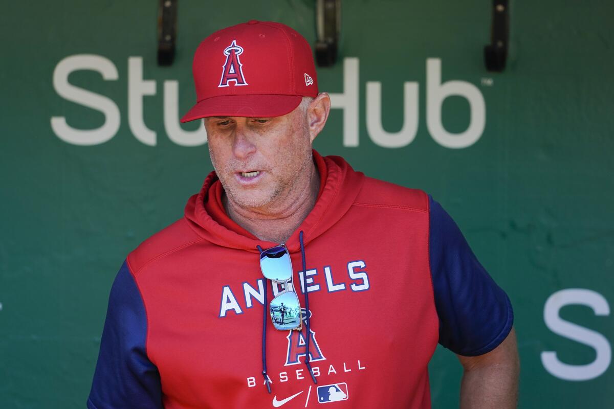 Los Angeles Angels manager Phil Nevin talks to reporters in the dugout before a baseball game against the Oakland Athletics in Oakland, Calif., Wednesday, Oct. 5, 2022. (AP Photo/Godofredo A. Vásquez)
