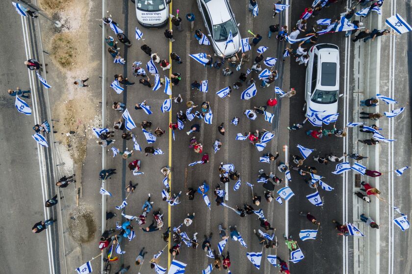 Israelis protest against plans by Prime Minister Benjamin Netanyahu's government to overhaul the judicial system in Beit Beit Yanai interchange, Israel as they block the free way Thursday, March 23, 2023. (AP Photo/Ariel Schalit)