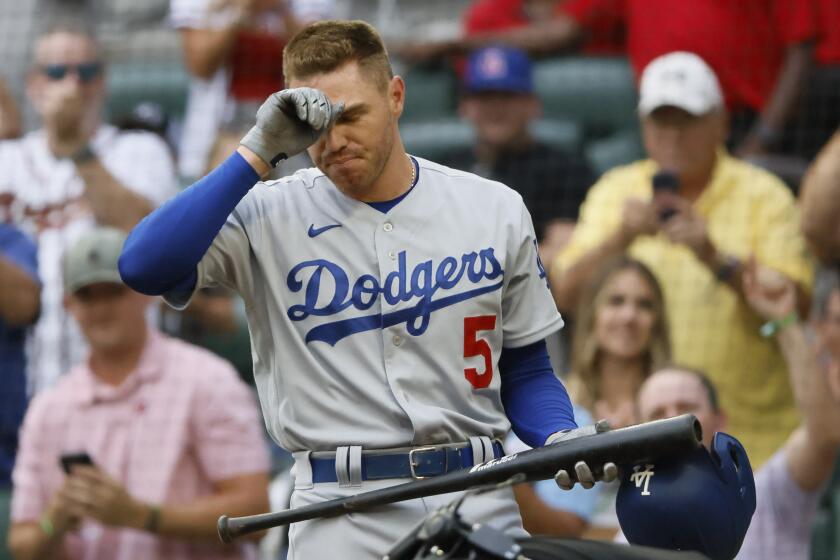 Los Angeles Dodgers' Freddie Freeman reacts to a standing ovation.
