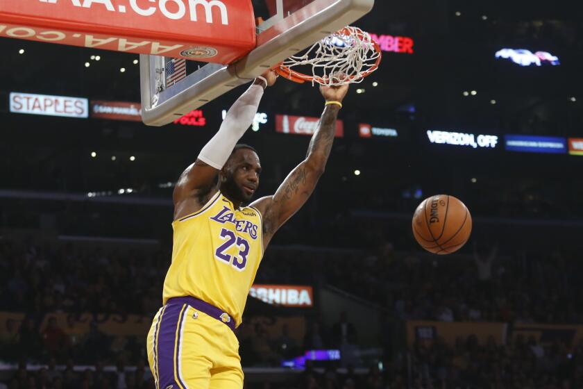 Los Angeles Lakers' LeBron James dunks during the first half of the team's NBA basketball game against the Oklahoma City Thunder on Tuesday, Nov. 19, 2019, in Los Angeles. (AP Photo/Ringo H.W. Chiu)