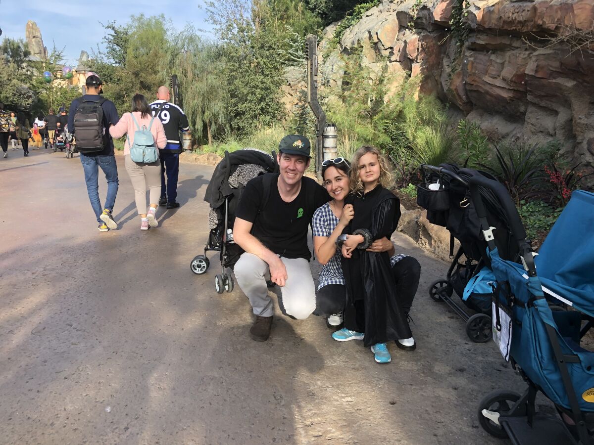 Josh Graves, his wife, Gabrielle Graves, and their 4-year-old son, Will, visit Star Wars: Galaxy's Edge in Disneyland on Thursday.