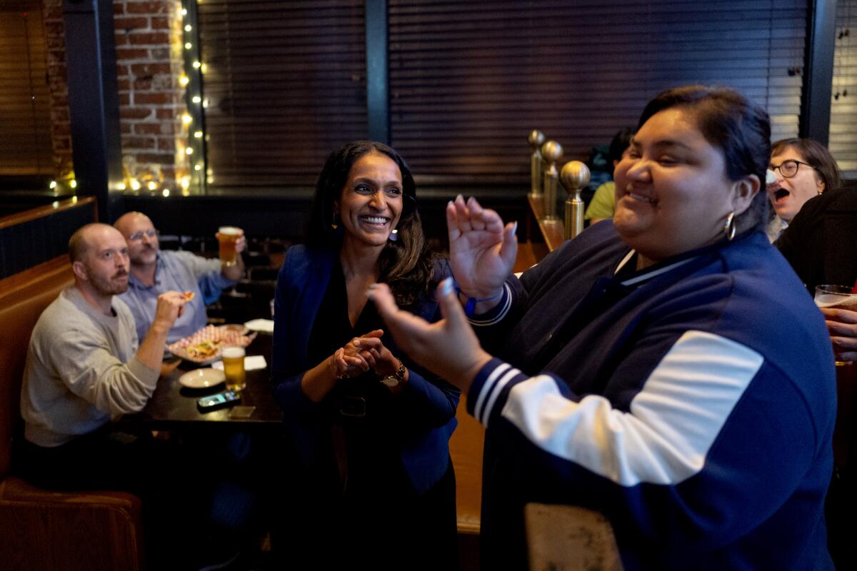 City Councilmembers Nithya Raman and Eunisses Hernandez celebrate at an election party.