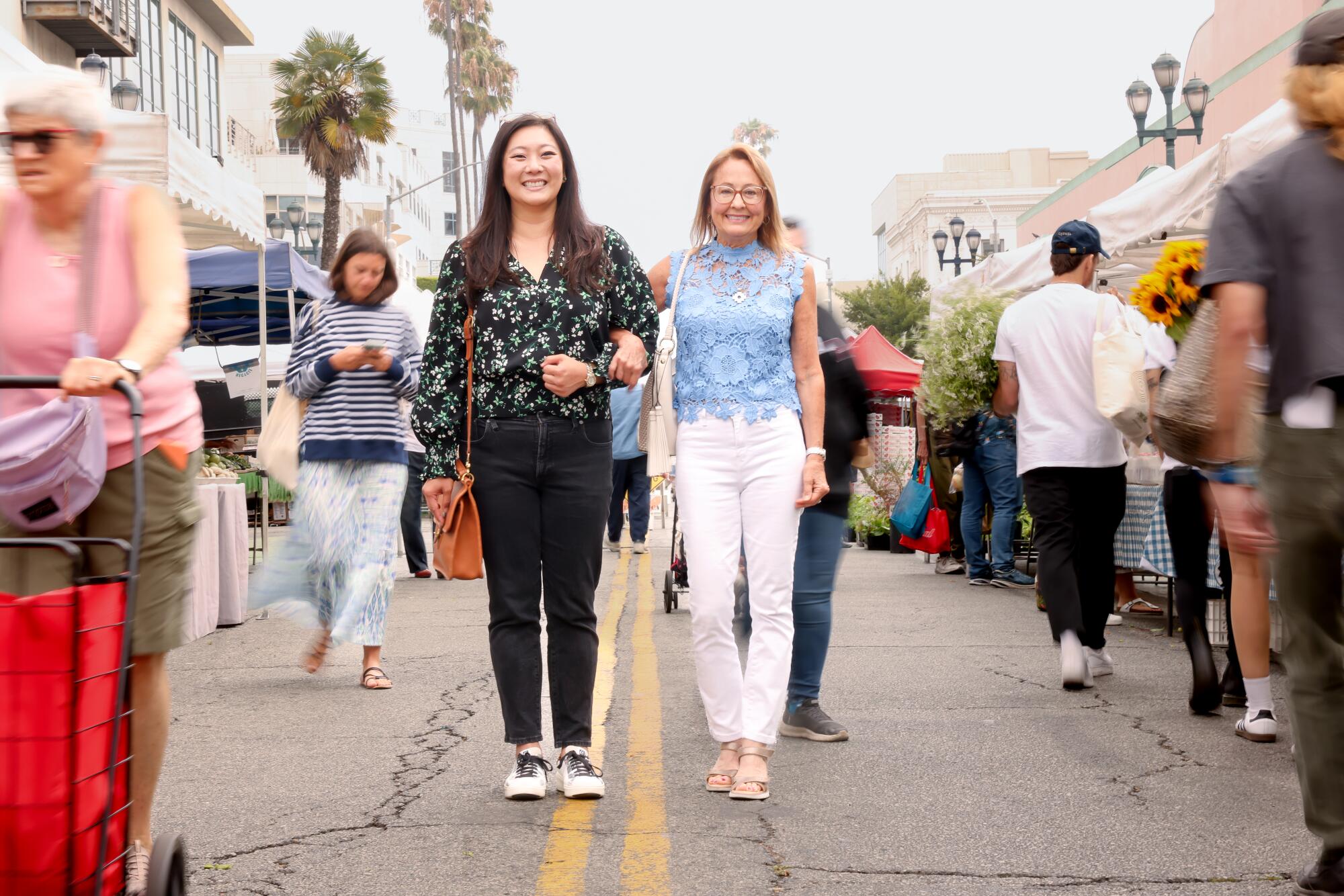 Friends Peggy Cheng, 40, left, and Karen Lektzian, 64, shop at the Santa Monica Farmer's Market.