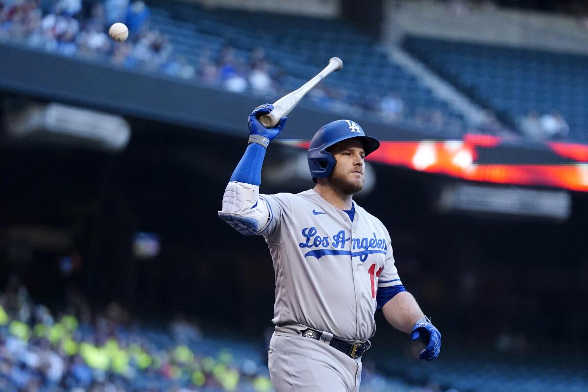 Dodgers first baseman Max Muncy tosses his bat after striking out.