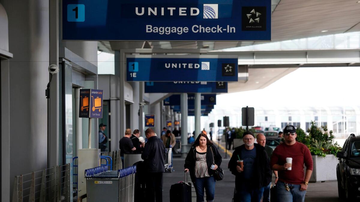 Travelers walk outside the United Airlines terminal at O'Hare International Airport on April 12, 2017 in Chicago, Illinois. / AFP PHOTO / Joshua LOTTJOSHUA LOTT/AFP/Getty Images ** OUTS - ELSENT, FPG, CM - OUTS * NM, PH, VA if sourced by CT, LA or MoD **