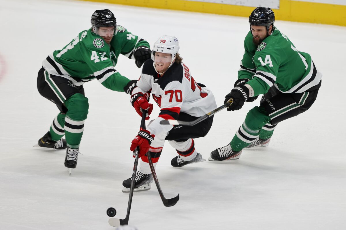 Dallas Stars left wing Marian Studenic (43) and left wing Jamie Benn (14) defend against New Jersey Devils center Jesper Boqvist (70) during the second period of an NHL hockey game in Dallas, Saturday, April 9, 2022. (AP Photo/Michael Ainsworth)