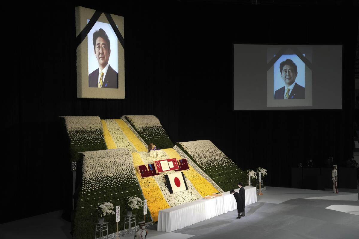 Japan's crown prince and his wife laying flowers at the state funeral of former Prime Minister of Japan Shinzo Abe