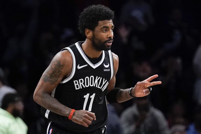 Brooklyn Nets' Kyrie Irving reacts after hitting a basket against the Cleveland Cavaliers.