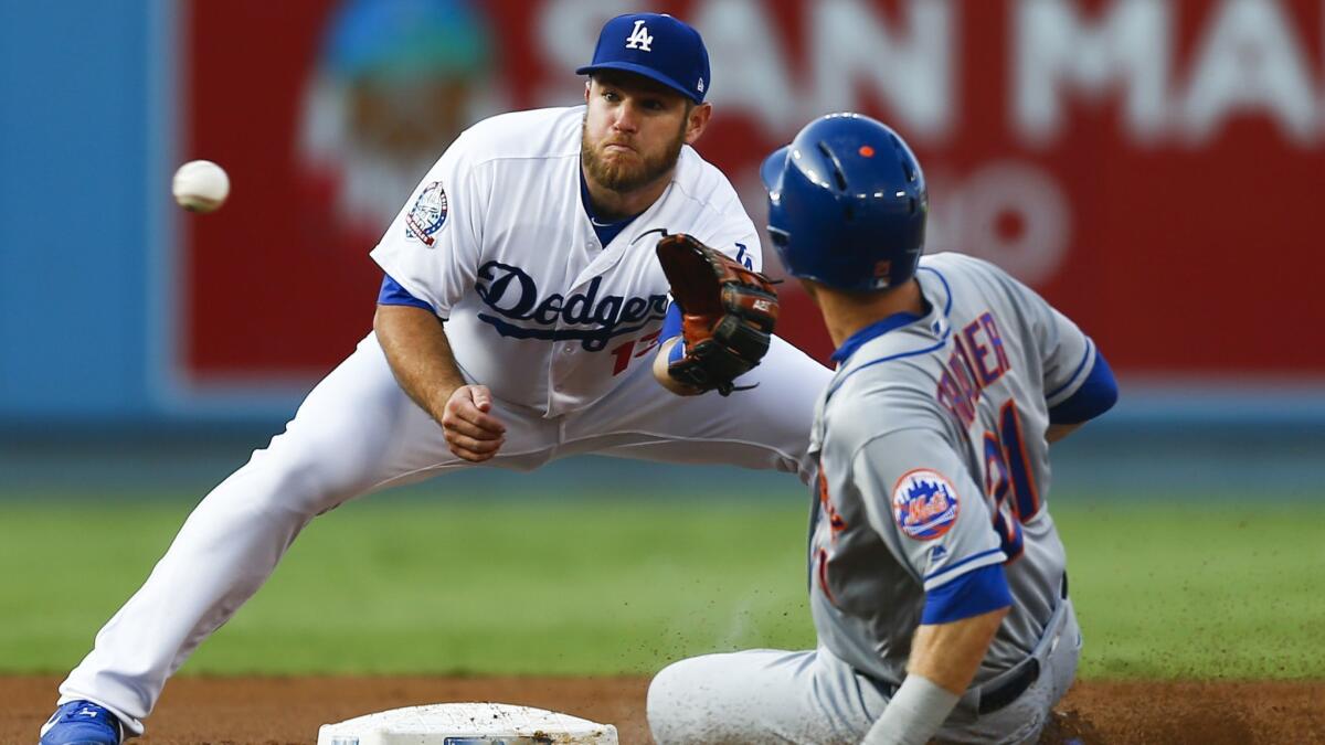 New York Mets third baseman Todd Frazier comes up short trying to steal second base, as Dodgers second baseman Max Muncy forces him out.