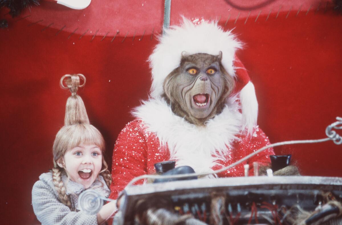 Taylor Momsen) and Jim Carrey in “Dr. Seuss’ How the Grinch Stole Christmas” (200)