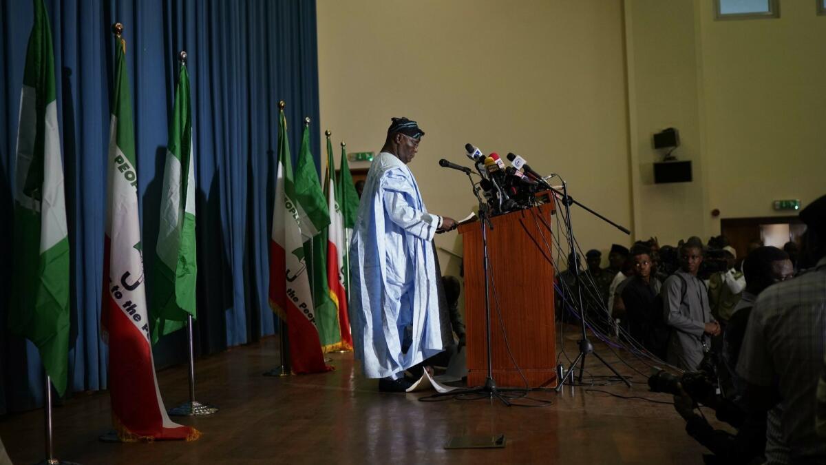 Defeated Nigerian opposition presidential candidate Atiku Abubakar reads a post-election statement Wednesday.