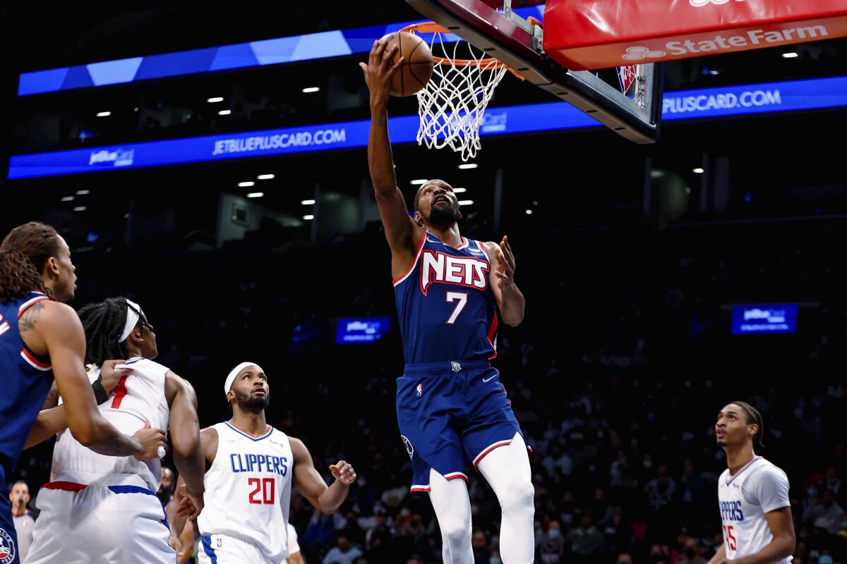 Brooklyn Nets forward Kevin Durant (7) shoots against the Los Angeles Clippers during the first half of an NBA basketball game Saturday, Jan. 1, 2022, in New York. (AP Photo/Jessie Alcheh)