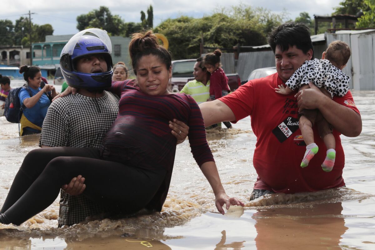 A pregnant woman is carried out of an area flooded by Hurricane Eta in Honduras, earlier this month.