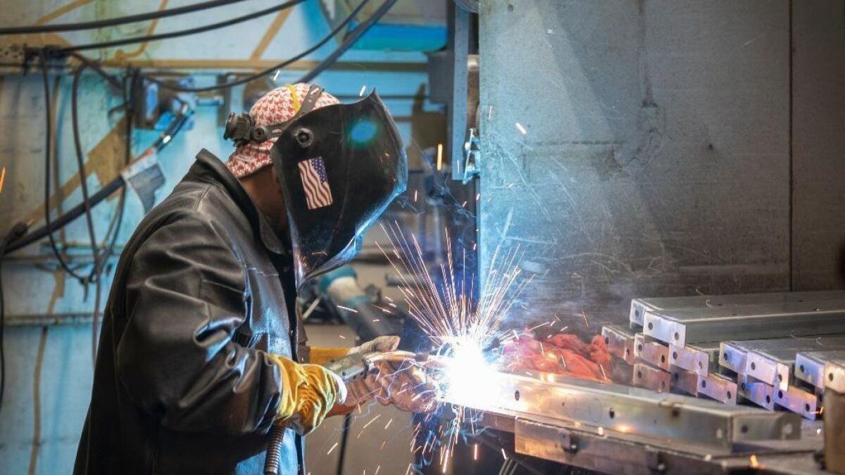 An employee of S. Bravo Systems welds metal parts for fiberglass tanks in City of Commerce, Calif. The company requires drug tests for all job applicants.