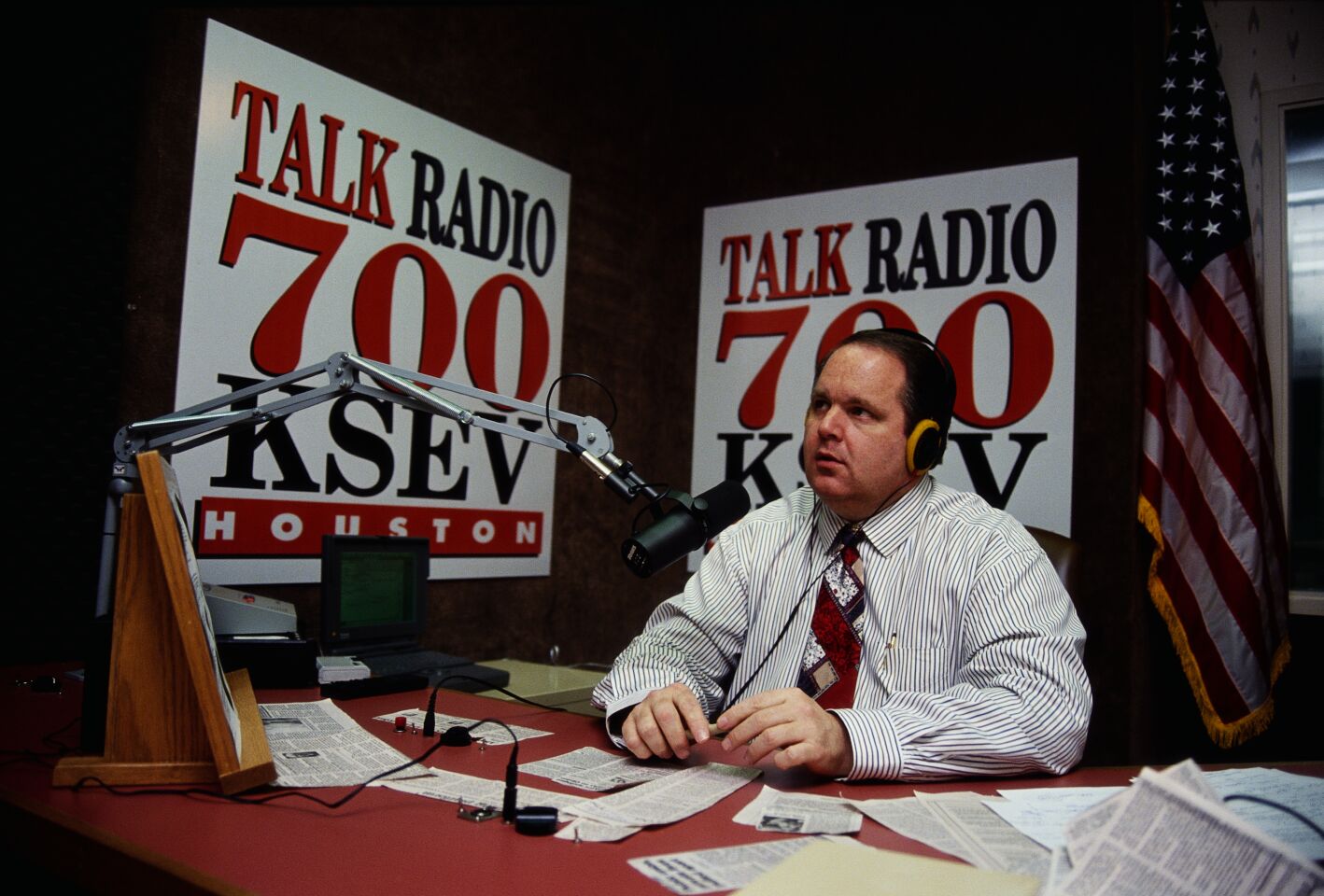 Rush Limbaugh behind a microphone.