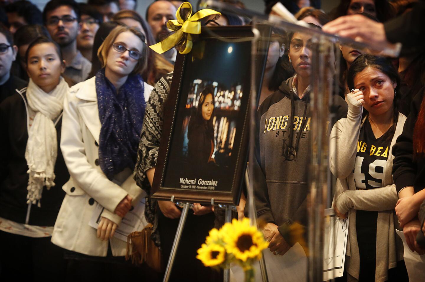 Mourners stand at a Nov. 15 Cal State Long Beach memorial service for 23-year-old industrial design student Nohemi Gonzalez, killed in the Paris terror attacks.