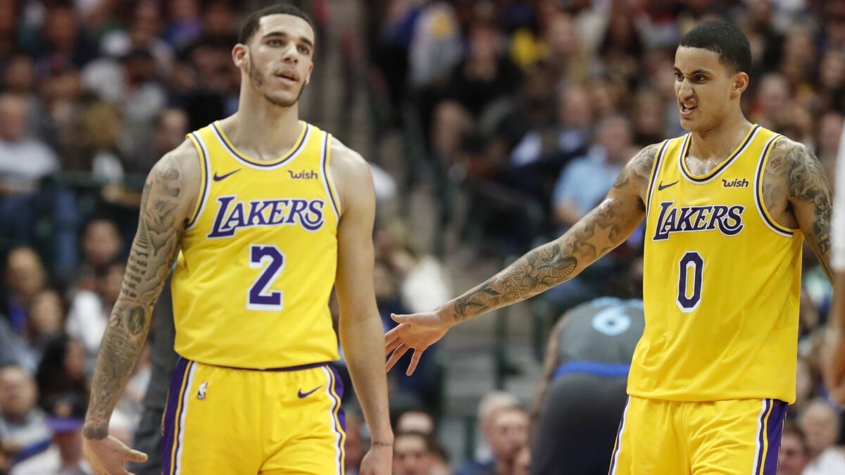 Lakers guard Lonzo Ball (2) and forward Kyle Kuzma (0) during the second half against the Dallas Mavericks on Monday.