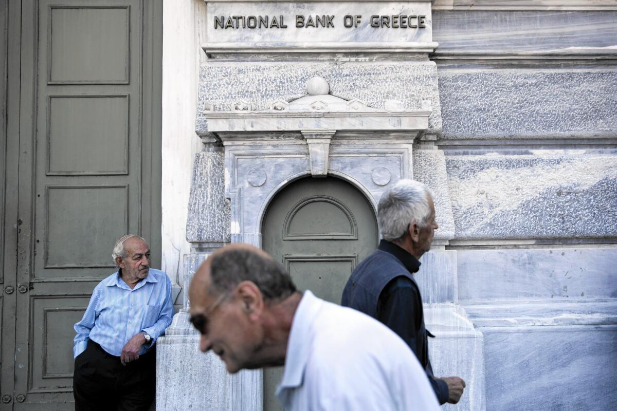 Pensioners wait outside a closed bank in Athens, hoping the facility would open so they could collect their benefits. To prevent further runs, the government closed banks for a week; some Greeks began stocking up on supplies.