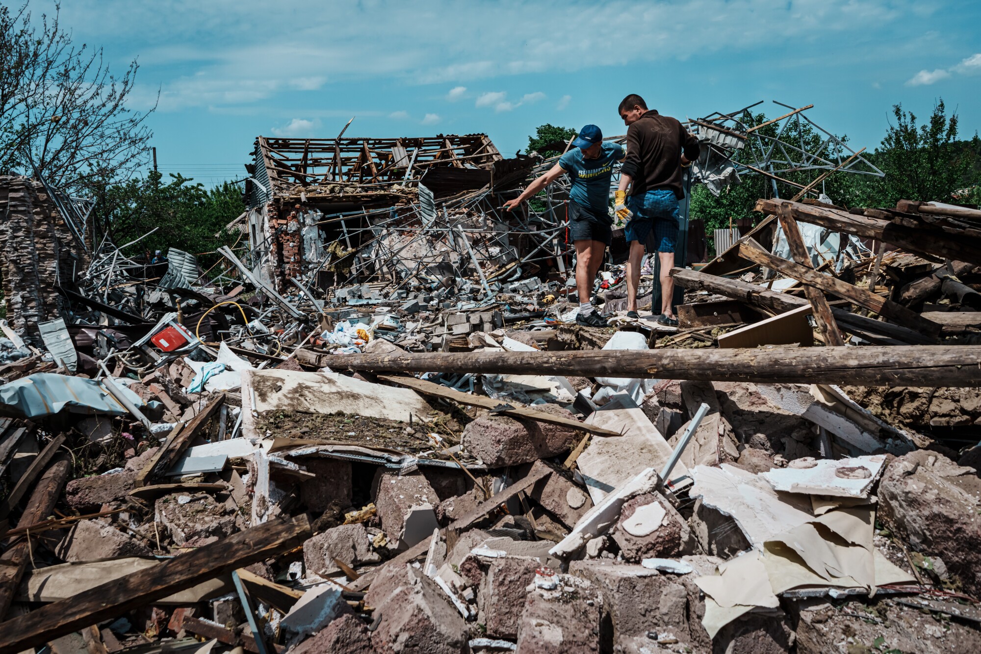 Residents at a house destroyed by a bomb.  