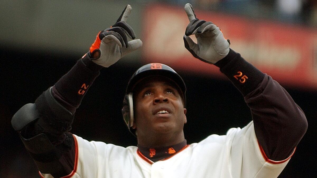 Barry Bonds points skyward after hitting his 701st career home run on Sept. 18, 2004.